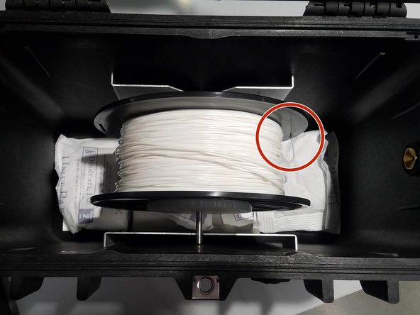 Wind the cut plastic filament back onto the spool