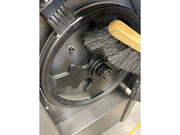 Open the door and using a brush, sweep the dust and shavings to the opening on the right. Be sure to dust off the wheel and door as well.