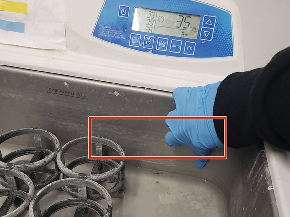 There should be water  in the bath, but if it's empty, fill it up to the faded line (see pic) with water from the sink