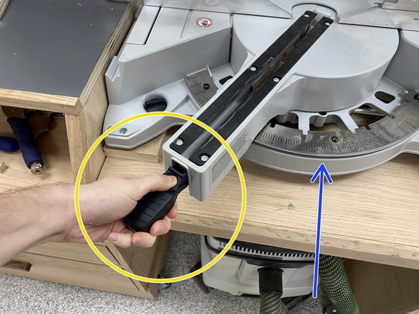 To angle the miter saw, push up on the black handle.