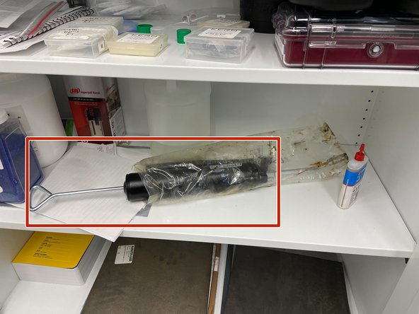 Grab the grease gun from the cabinet