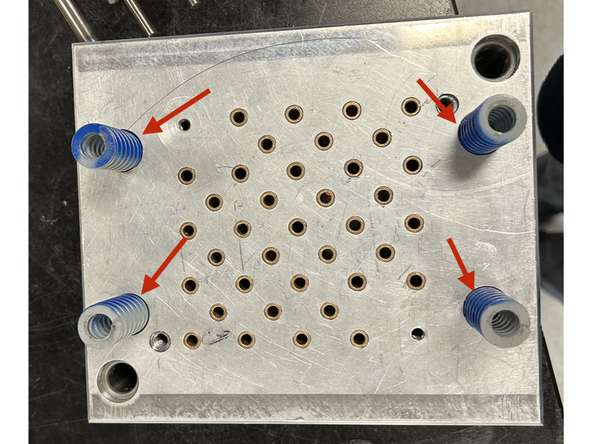 Insert the 4 springs into their pockets in the back of the ejection pin mud plate.