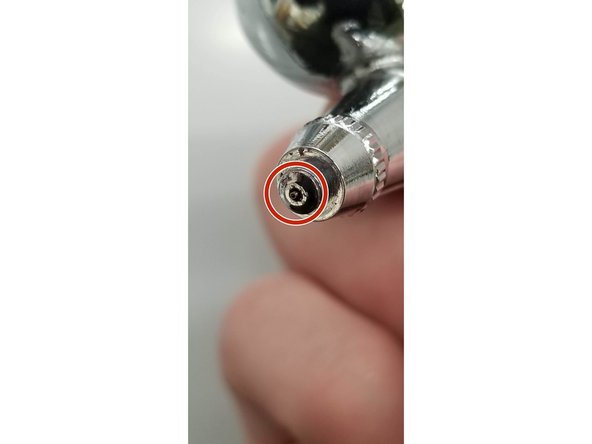 You can carefully unscrew the needle guard surrounding the needle to get a better look. The pictures here show the brush with the guard on, and then two with the guard off showing the needle out and then in.