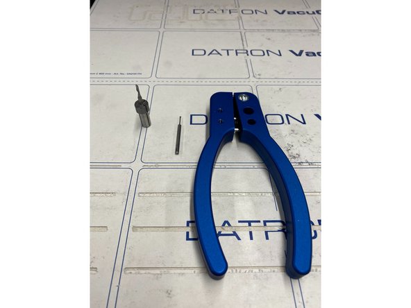 After selecting your new tool to insert, place the collet in the shown device and clamp down a little bit, just enough to release the tool.