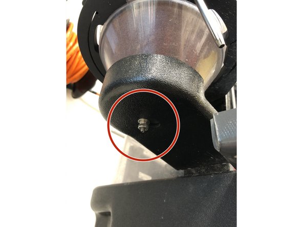 Screw off the hopper splash guard nut.