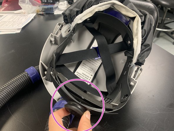 Adjust the sizing on the head cover by twisting the knob and pulling the strap on the waistband. Strap them on.