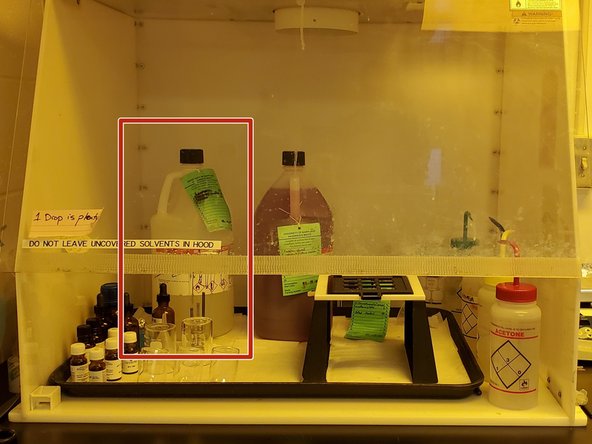 Pour the beaker with the pre-wash chemicals into the left container.