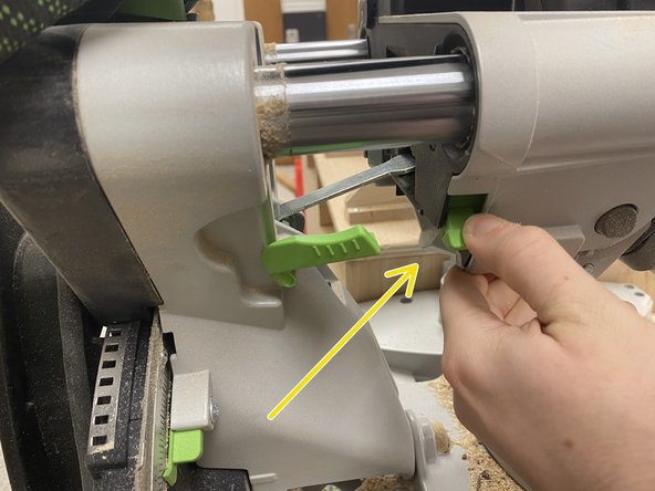 The saw head should then be pushed back into the metal arm to lock it into place.