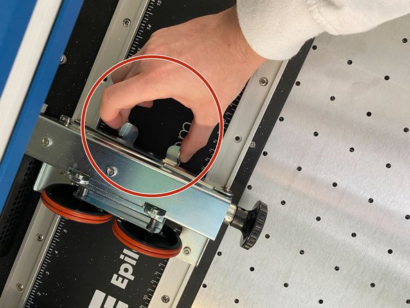 The rotary attachment can be adjusted laterally by squeezing the tabs to move the scissor jack left and right.