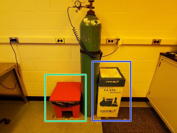 The nitrogen tank is located to the left of the fume hood.