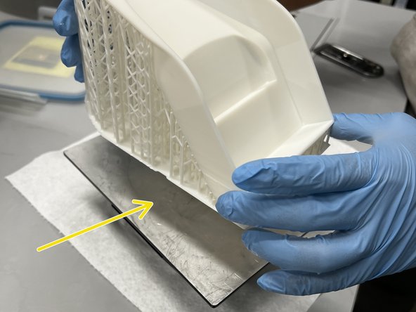 Once a corner is separated, use a metal scraper to slowly lift up more of the raft.