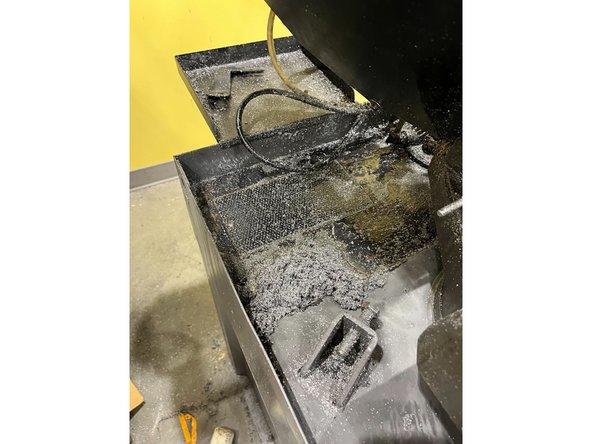 Use a paper towel to collect the chips and throw them in the trash can (NOT the rectangular bin with metal scraps)