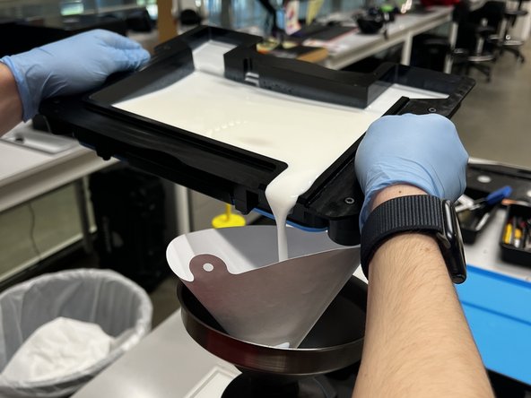 Gently pick up the tank and pour the resin into the paper filter using the pouring spout on the bottom right of the tank.