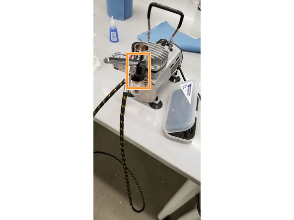 The brush can be stored in the plastic mounting piece on the air compressor when not actively in use.