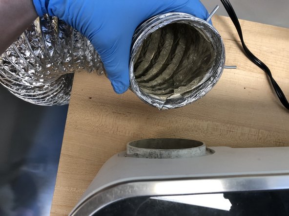 There's another circuit board on the left side of the GF. Use compressed air to clean this off as well.