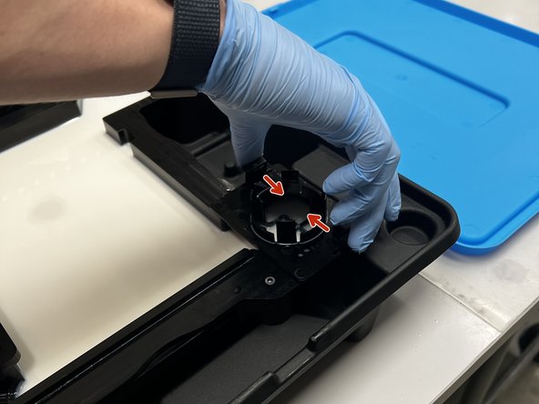 Locate the spout on the top right of the tank. Pinch both clips inwards to remove