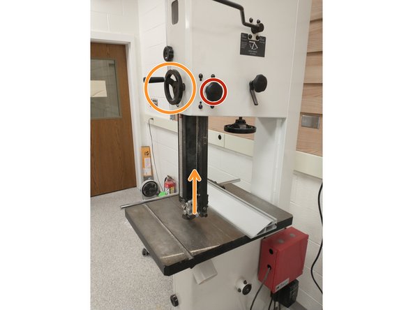 To move the blade guard, you must turn the lock knob situated on the back of the bandsaw.