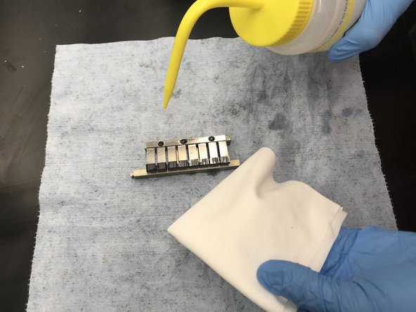 Set the wiper on a blue towel and Isopropyl Alcohol and a microfiber cloth