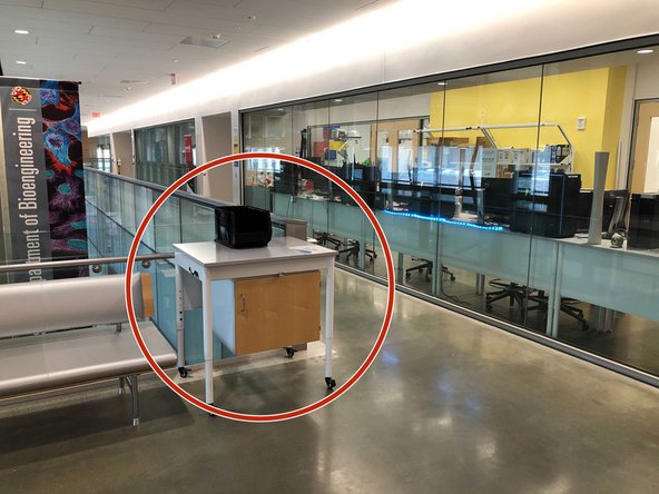 Find the pickup and dropoff table near the couch on the upper concourse