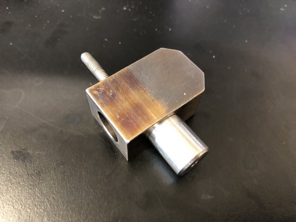 Unscrew garnet dropping tube from main body of abrasive block.