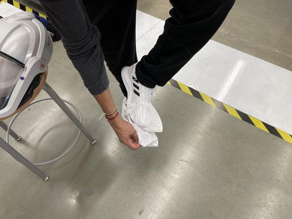 Remove booties inside out and dispose appropriately in pink waste container