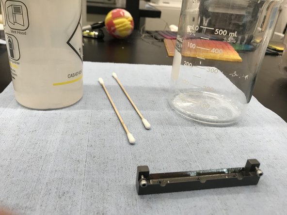 Using Isopropyl Alcohol, spray down the roller bath into the beaker