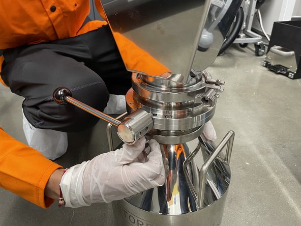 Once powder has settled, close the lever by pulling out, turning and making sure it locks back into a fully closed position