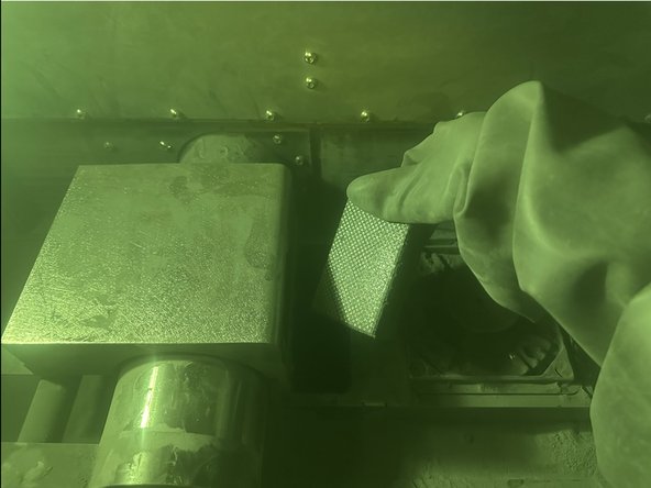 There is no easy way to do this. You may need to press the sanding block against the Carriage or wall of the Powder Supply.