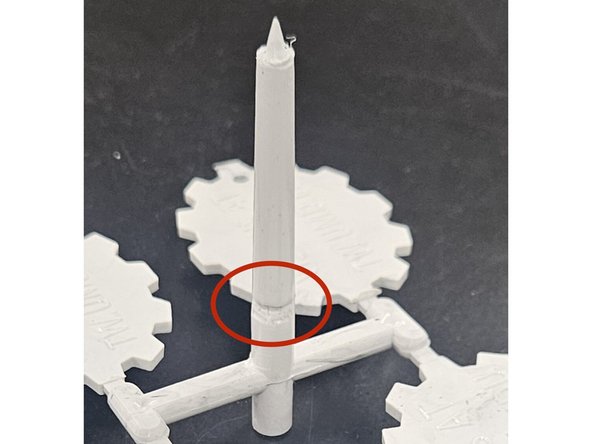 Solution: Remove the plate from the machine. Using a smaller sized allen key, hammer the sprue through with a mallet so that the part comes out.