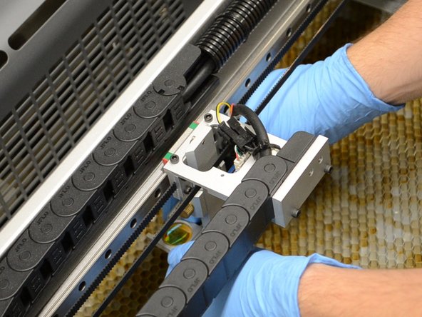 Remove the lens from the machine.