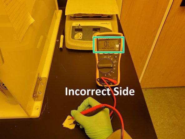 The coated side should have a resistance of 100-300 ohms. The glass side should have an OL reading.