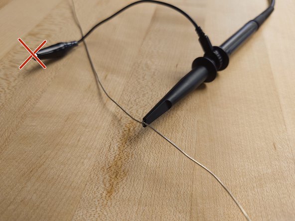 Pull back the cover of the probe to see the hook. Hook this over the wire, or whatever else you want to measure from.