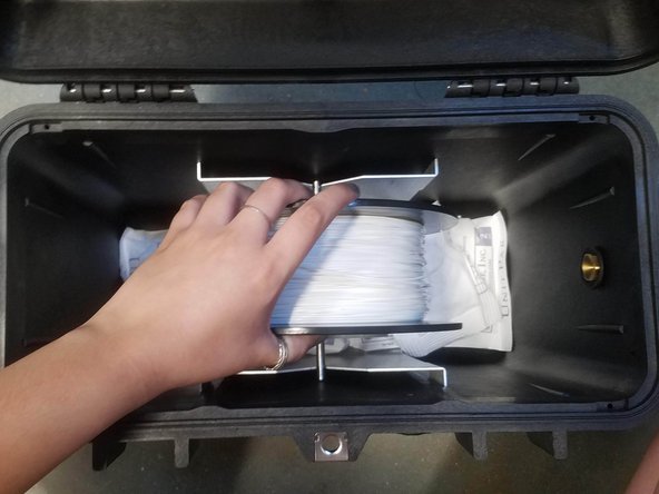 Always hold the plastic against the spool to prevent unwinding during the loading routine