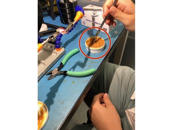 Use a small brush and gently dab it in some water soluble paste flux.