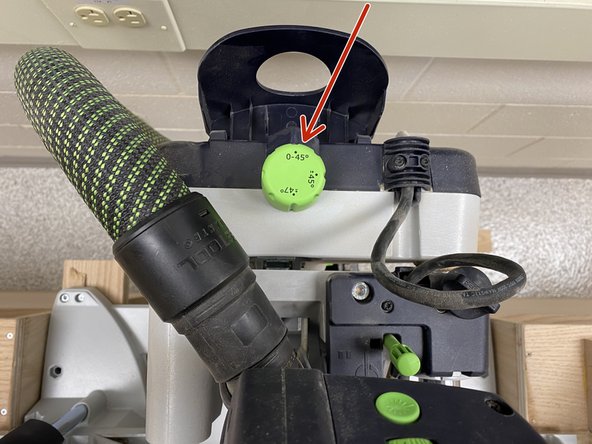 Once the cover on the back is flipped up, the saw will move freely.