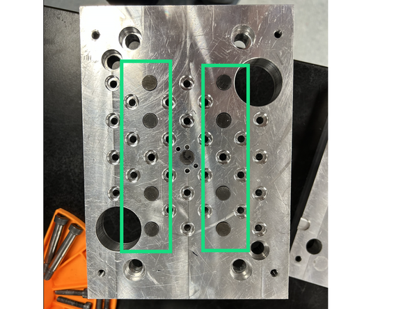 Insert the outer ejection pins into their corresponding holes.