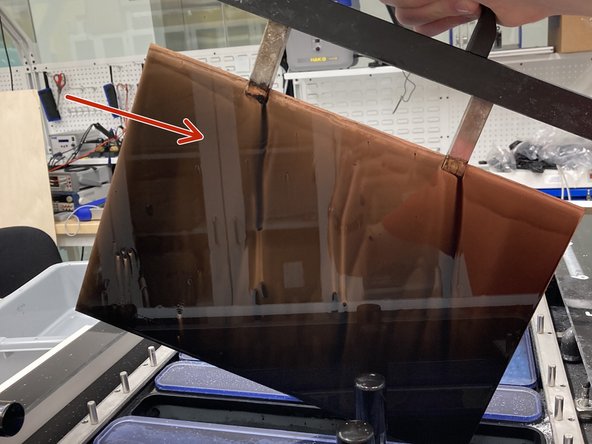 Once bath 3 is complete, lift the board out of the bath and scrape ink off the surface back into the bath