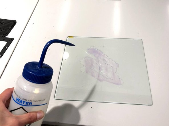 Scrape off any excess filament that is still adhered to the build plate with a rounded-edge spatula