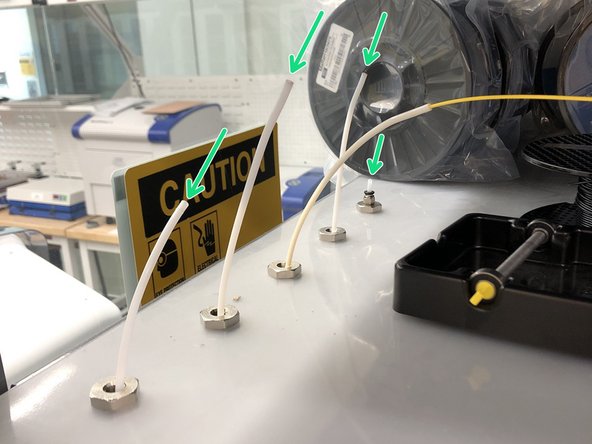 Feed the filament through one of the PTFE tubes above the printer