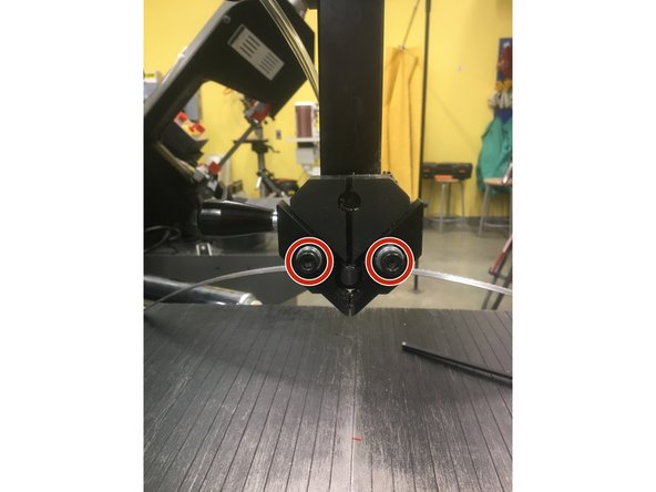 Ensure that the new blade is seated against the lip at the back of both drive wheels, within the guides, and behind the left red guard.