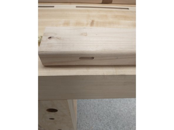 Depress the lever shown and push the handle of the machine into the head.