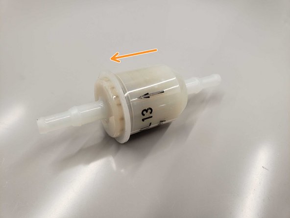 The arrow indicates which way the chemical should flow through the filter