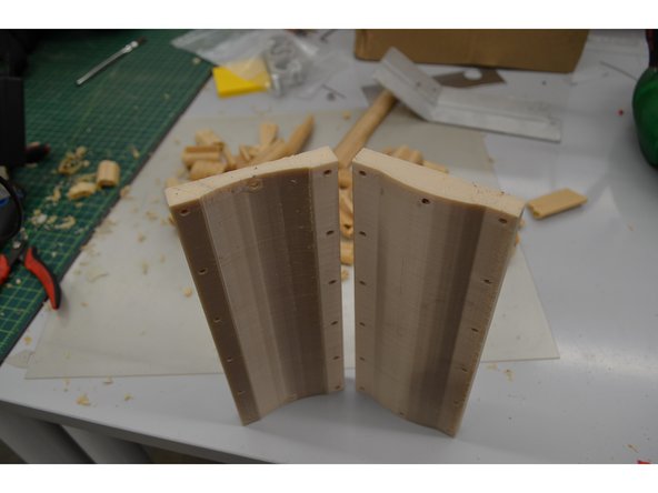 Even if the part is cool enough to touch, keep a glove on the hand you plan to hold the part with. This will protect you from the sharp, brittle support material and from the tools you use