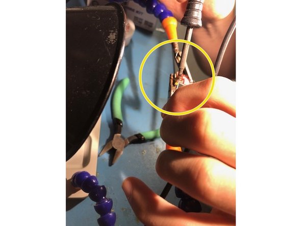 While holding the soldering iron on the pin and socket being to push the soldering wire onto the pin.