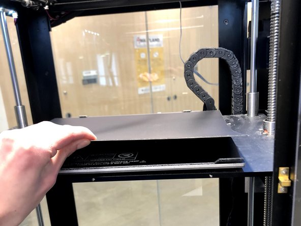 Return the build plate to the machine pressing up against the onyx spacing blocks at the back