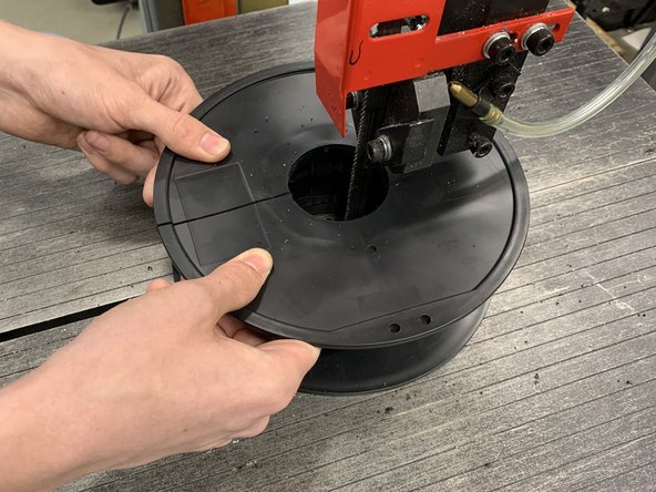 Then rotate the spool and take the blade through the path you just cut so you can remove the spool.