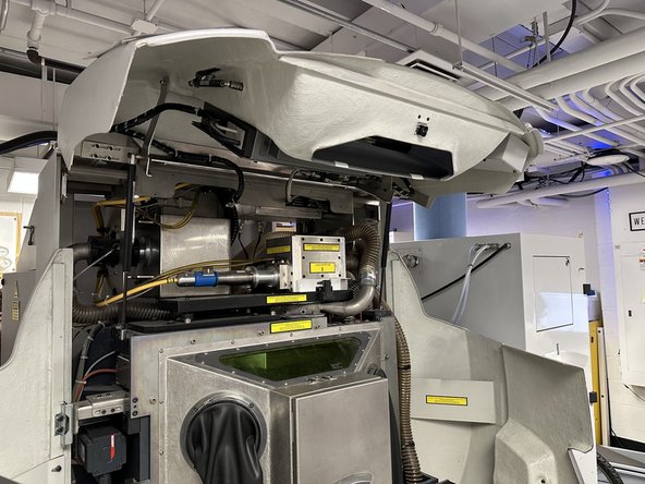 Raise the front cover by lifting on the grey handholds.