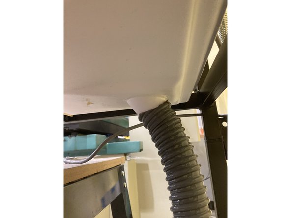 Make sure that the small orange and black vacuum cleaner is attached to the base of the powder coating tub