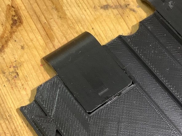 Test-fit the lip. It should fit easily into place. Trim the tail of the drum spring, and the lip, if necessary.