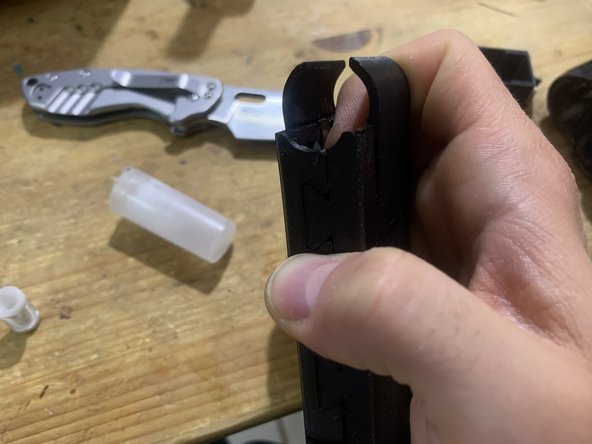 Apply a single drop of glue under both sides of the top locking tab.